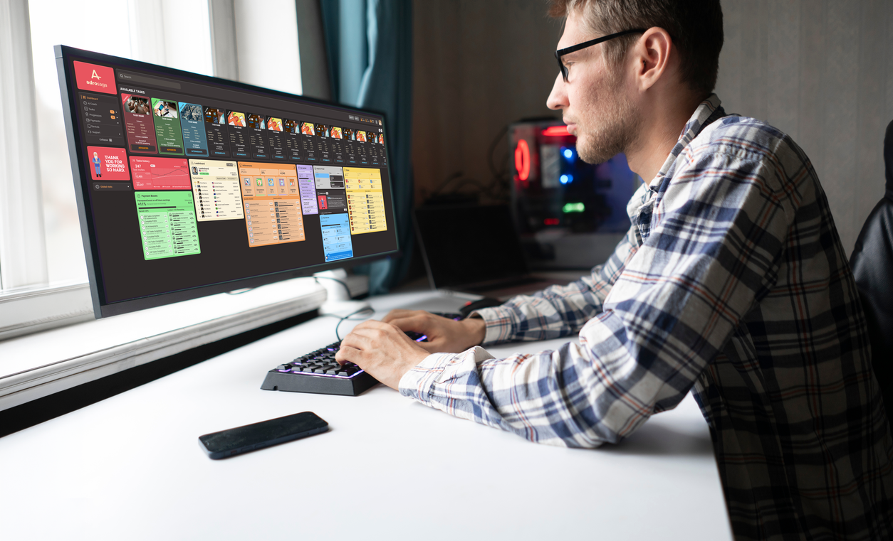 A validator at a desk reviewing the Adrosaga platform on a large monitor